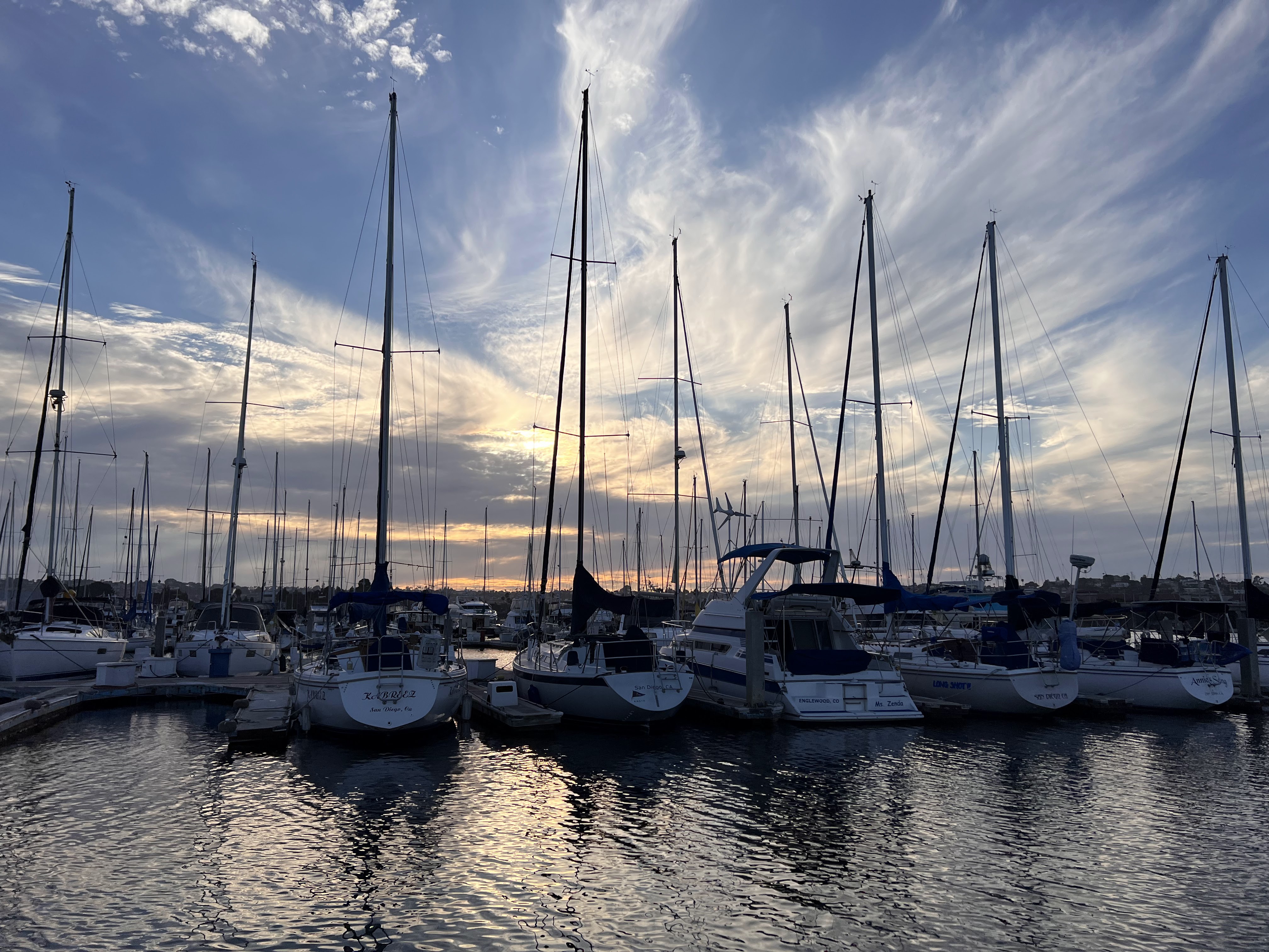 Marina full of sailboats at sunset